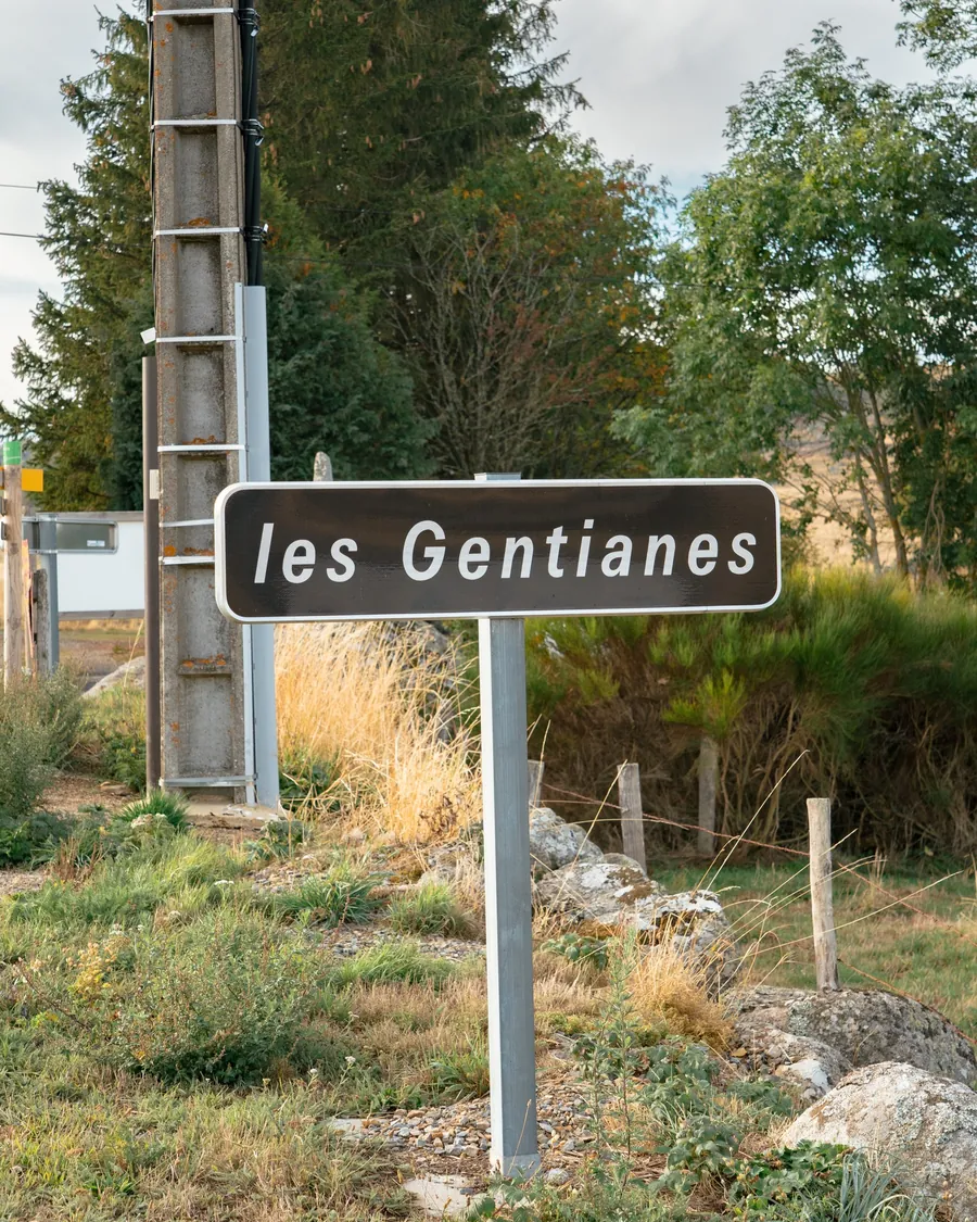 Le panneau du lieu-dit « les Gentianes », au bord de la route : le carrefour où la variante par Malbouzon rejoint le GR 65
